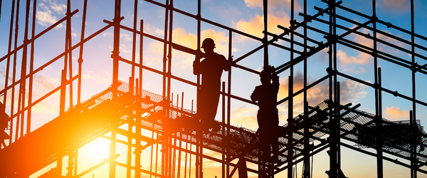 Construction works and scaffolding with a sunset behind