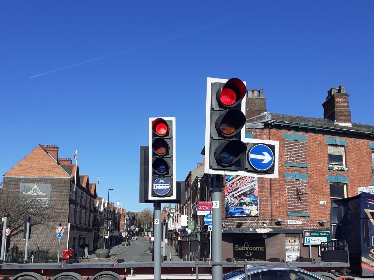 Bus lane signage on the traffic lights looking down Bridge Street